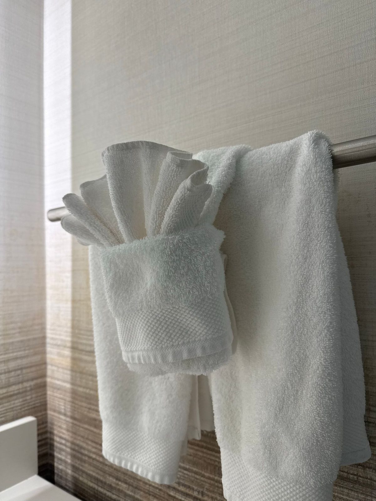 Folded stack of white hand towels